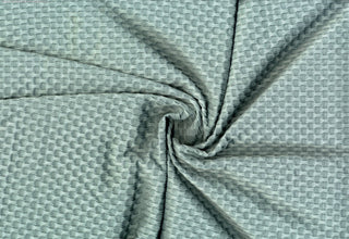 Stretch knit fabric featuring a raised honeycomb pattern with a structured, textured jacquard weave ALOE