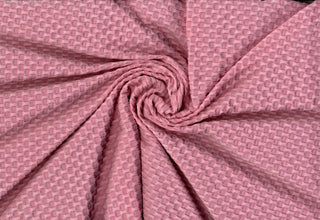 Stretch knit fabric featuring a raised honeycomb pattern with a structured, textured jacquard weave PINK