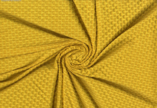 Stretch knit fabric featuring a raised honeycomb pattern with a structured, textured jacquard weave YELLOW