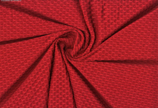 Stretch knit fabric featuring a raised honeycomb pattern with a structured, textured jacquard weave RED