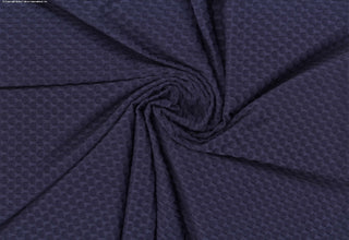 Stretch knit fabric featuring a raised honeycomb pattern with a structured, textured jacquard weave NAVY