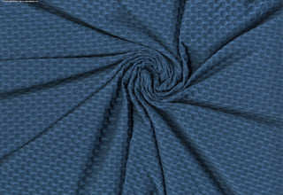 Stretch knit fabric featuring a raised honeycomb pattern with a structured, textured jacquard weave INK