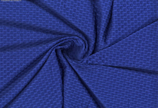 Stretch knit fabric featuring a raised honeycomb pattern with a structured, textured jacquard weave ROYAL