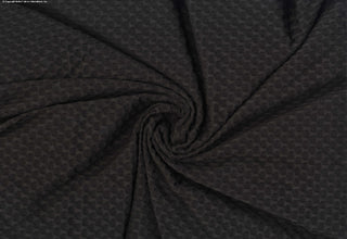 Stretch knit fabric featuring a raised honeycomb pattern with a structured, textured jacquard weave BLACK