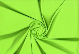 Power Skin stretch knit fabric with 4-way stretch, ideal for activewear, swim, and fashion projects. NEON GREEN