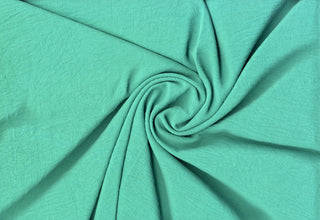 Lightweight woven fabric featuring a soft, textured surface with an airy, flowing, elegant drape PARIS GREEN