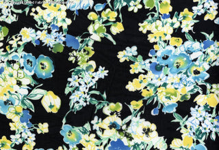 A floral pattern with large poppies and smaller flowers, scattered with leaves on a background. B/TURQ
