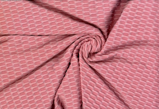 Textured honeycomb knit pattern with dimensional raised geometric shapes for dynamic designs PINK