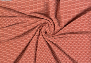 Textured honeycomb knit pattern with dimensional raised geometric shapes for dynamic designs SALMON