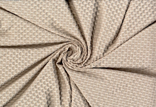 Stretch knit fabric featuring a raised honeycomb pattern with a structured, textured jacquard weave OATMEAL