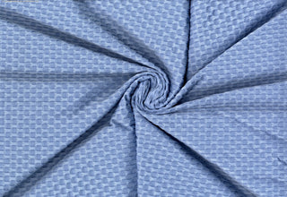 Stretch knit fabric featuring a raised honeycomb pattern with a structured, textured jacquard weave CHAMBRAY