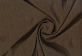 Textured crepe fabric with subtle two-tone weave and fluid drape for dressmaking and décor projects