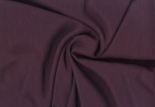 Textured crepe fabric with subtle two-tone weave and fluid drape for dressmaking and décor projects PLUM
