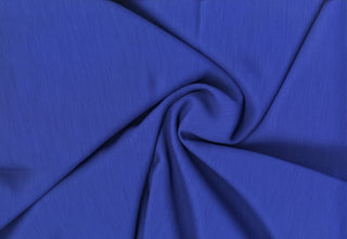 Textured crepe fabric with subtle two-tone weave and fluid drape for dressmaking and décor projects ROYAL