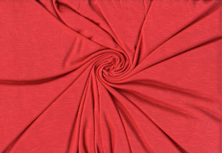 Soft stretch slub jersey knit in 100% polyester, ideal for DIY apparel, crafts, and sublimation. CORAL