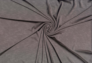 Soft stretch slub jersey knit in 100% polyester, ideal for DIY apparel, crafts, and sublimation. CHARCOAL