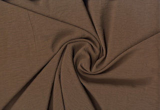 Lightweight woven fabric featuring a soft, textured surface with an airy, flowing, elegant drape