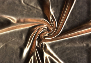 Stretchy lame fabric with glossy, mirror-like finish and sleek, fluid texture for flexible designs