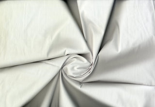 Smooth poplin weave with gentle stretch and minimal surface variation for tailored looks