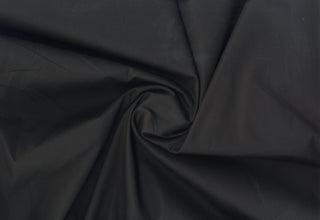 Plain weave cotton with soft stretch and fine, smooth surface ideal for tailored or flowing projects